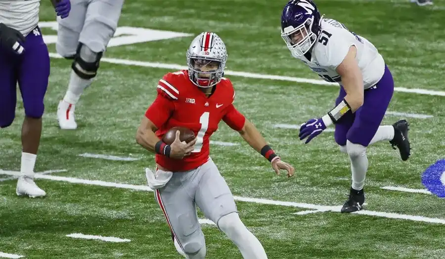 Justin Fields in Ohio State uniform preparing to throw