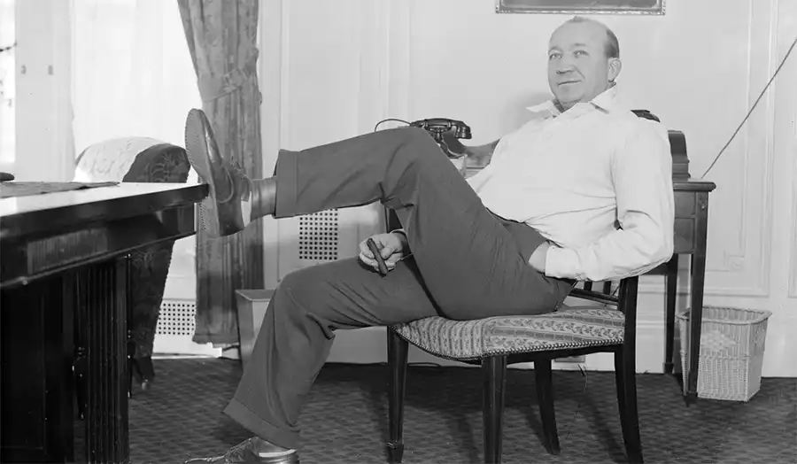 Knute Rockne posing in his Notre Dame uniform, symbolizing the program’s early era
