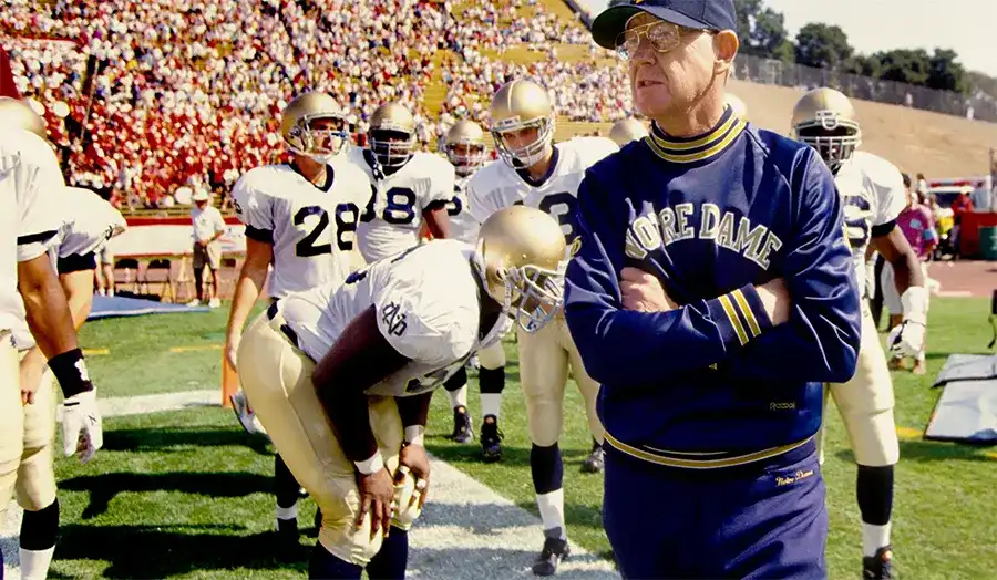 Lou Holtz coaching Notre Dame players on the sidelines