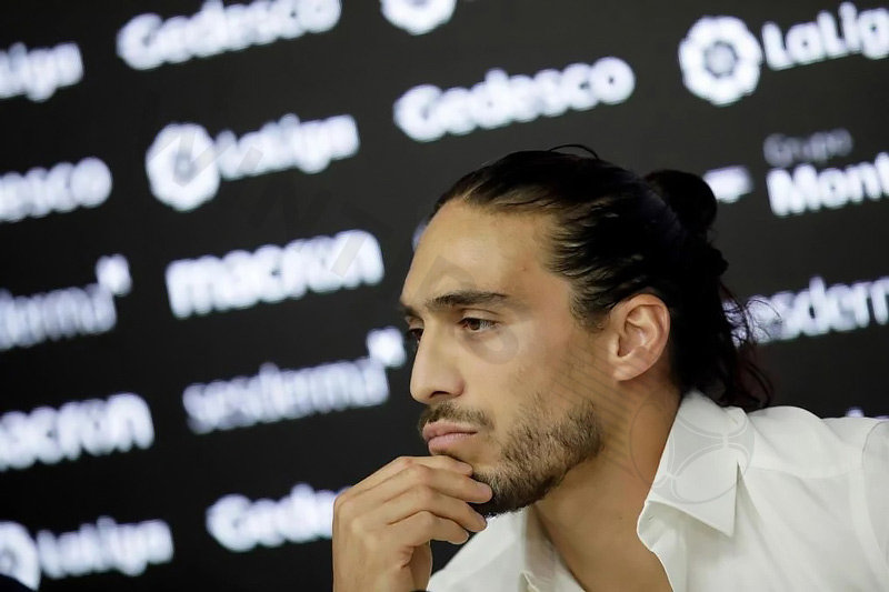 Midfielder Martin Caceres with long hair and headband while playing at Juventus